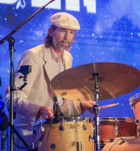 Wishgarden drummer Daniel Kshywonis at drum kit on stage.